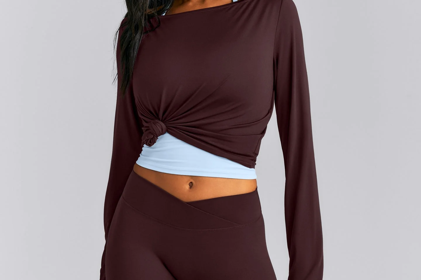 Pilates Edit cover: a model wearing the Oner Active FormeSoft Slash Neck Long Sleeve Top in plum brown