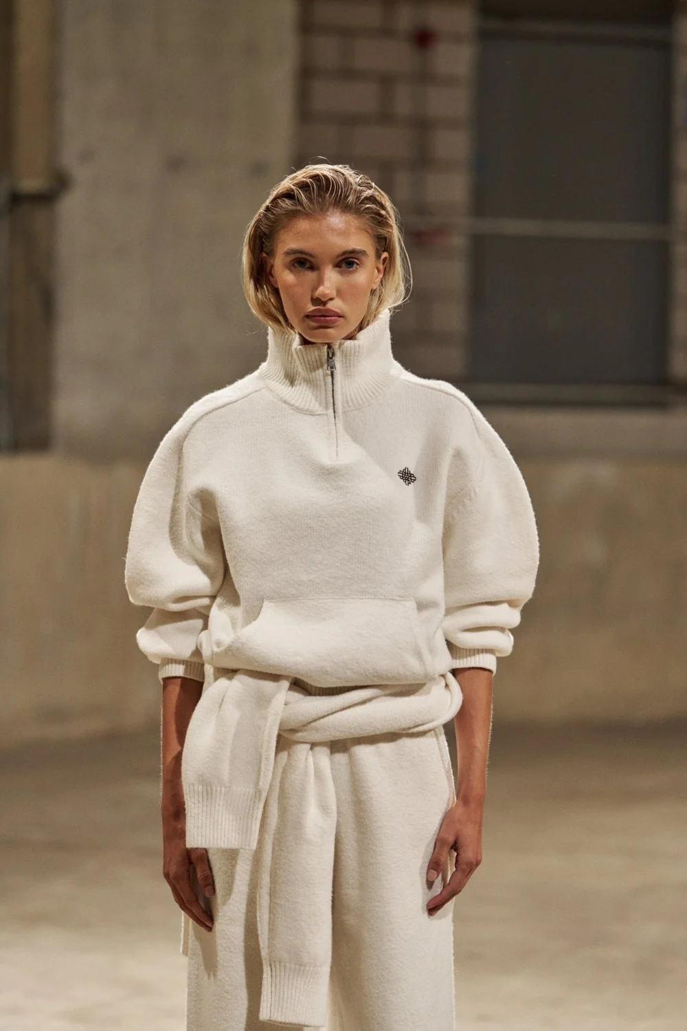 The Couture Club campaign: cream quarter-zip sweatshirt and matching relaxed trousers